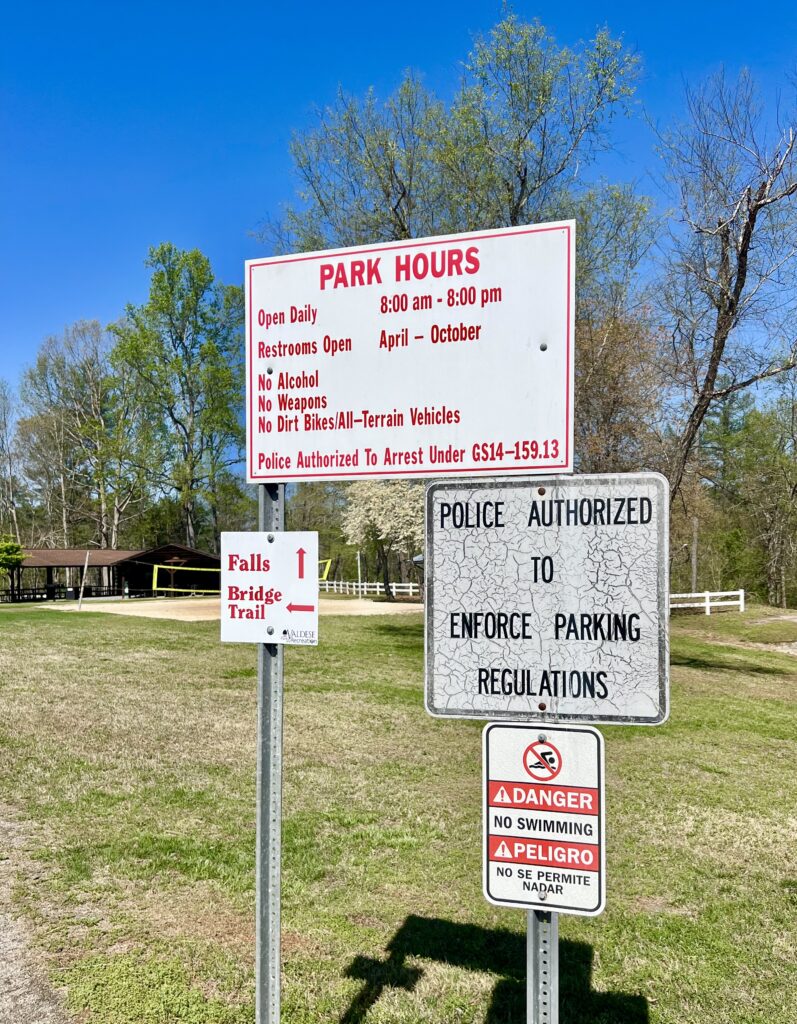 park rules sign at mcgalliard falls park in valdese nc, includes note of no swimming allowed